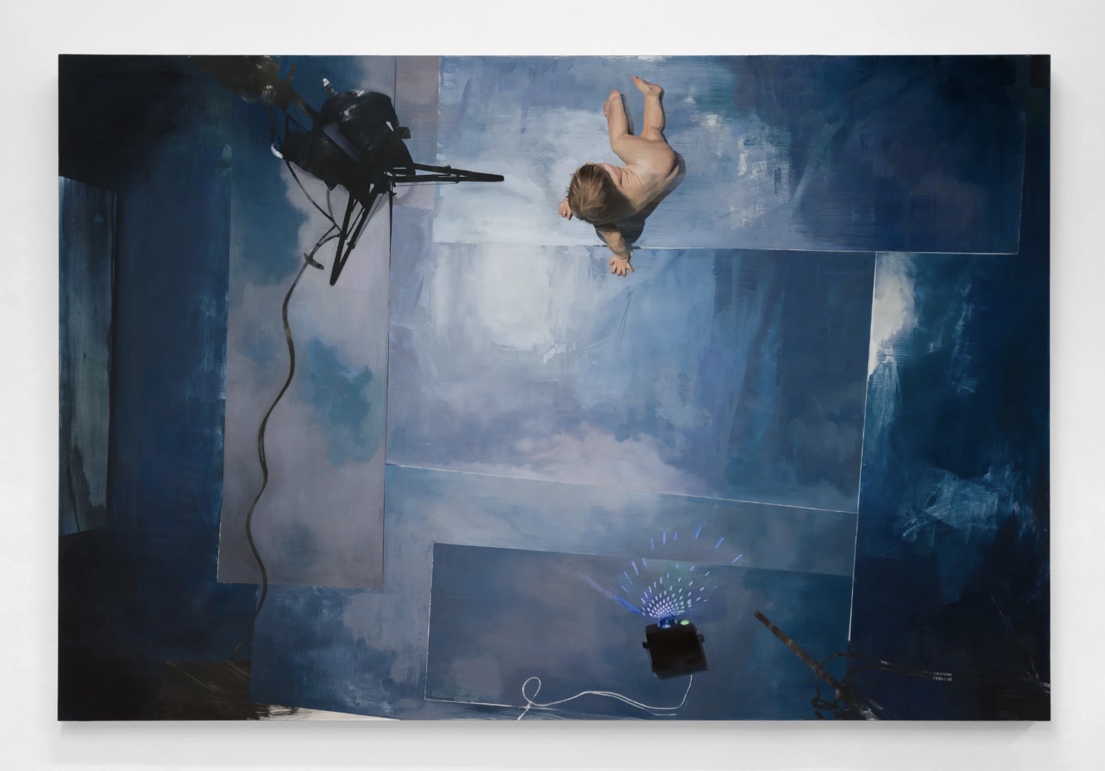 Painting seen from above: panels painted as a cloudy sky, a naked baby crawling at the top, a lamp on its stand trailing cable at upper left, a small star projector throwing blue light at the bottom